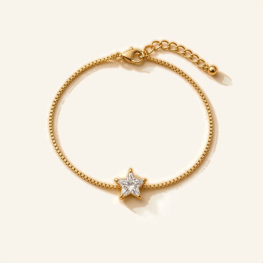 Denoon London gold-tone crystal bracelet with extender, star design, flat lay