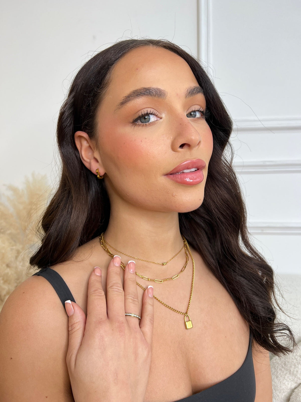 Denoon London layered padlock necklace with heart worn on a model, gold-tone shown