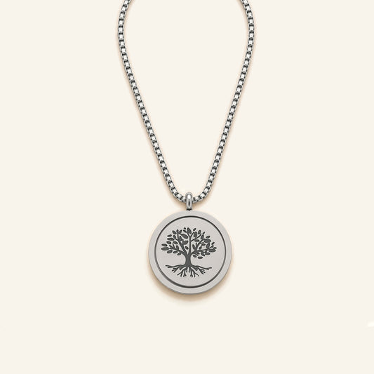 Denoon London Serenity Prayer necklace with Tree of Life spinning pendant in silver-tone, flat lay on cream