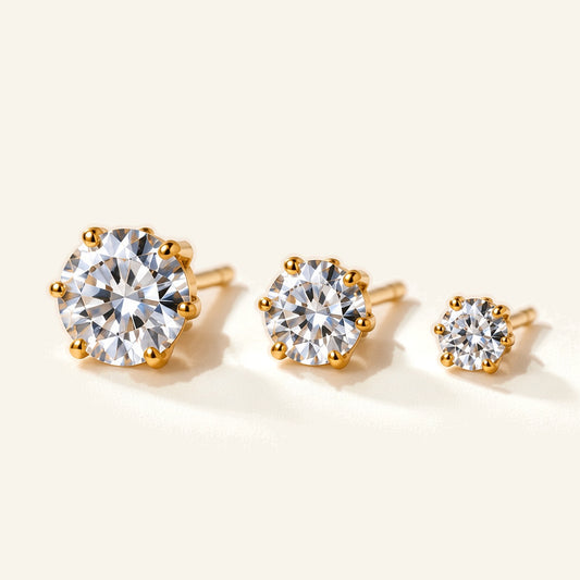 Denoon London solitaire crystal stud earrings, set of three in gold-tone, flat lay on cream