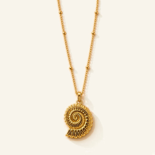 Denoon London shell pendant necklace in gold-tone, flat lay