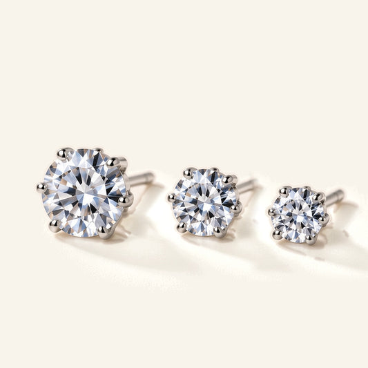 Denoon London Solitaire Crystal Stud Earrings Set of 3 in silver-tone, 6mm, 5mm and 4mm, flat lay on cream