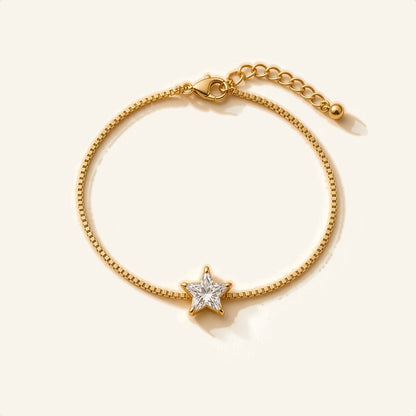 Denoon London gold-tone crystal bracelet with extender, star design, flat lay