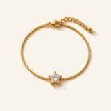 Denoon London gold-tone crystal bracelet with extender, star design, flat lay