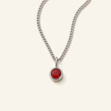 Denoon London Birthstone necklace with crystal birth month pendant in silver-tone, 45cm, flat lay on cream