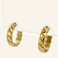Denoon London chunky twisted hoop earrings, gold-tone, side view on cream