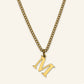 Denoon London Classic Initial necklace, gold-tone letter M, on cream