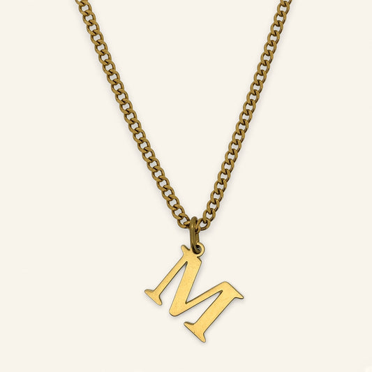 Denoon London Classic Initial necklace, gold-tone letter M, on cream