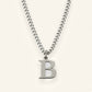 Denoon London Classic Initial necklace, silver-tone letter B, on cream