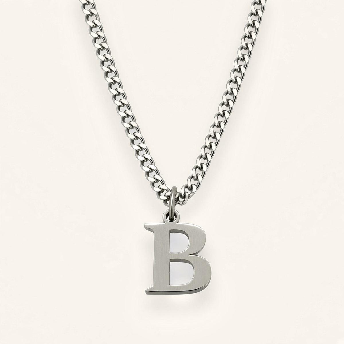 Denoon London Classic Initial necklace, silver-tone letter B, on cream