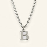 Denoon London Classic Initial necklace, silver-tone letter B, on cream