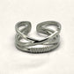 Denoon London crossover statement ring, silver-tone, styled on cream