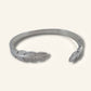 Denoon London double feather adjustable bangle, silver-tone, on a cream background