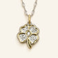 Denoon London Four Leaf Heart Clover Necklace, silver-tone: close-up of the clover pendant with gold-tone edges and a centre crystal