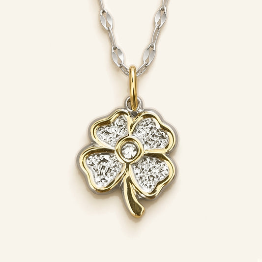 Denoon London Four Leaf Heart Clover Necklace, silver-tone: close-up of the clover pendant with gold-tone edges and a centre crystal