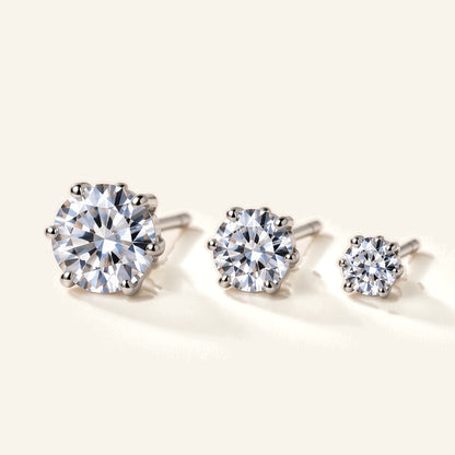 Denoon London solitaire crystal stud earrings, set of three in silver-tone, flat lay on cream