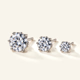 Denoon London solitaire crystal stud earrings, set of three in silver-tone, flat lay on cream