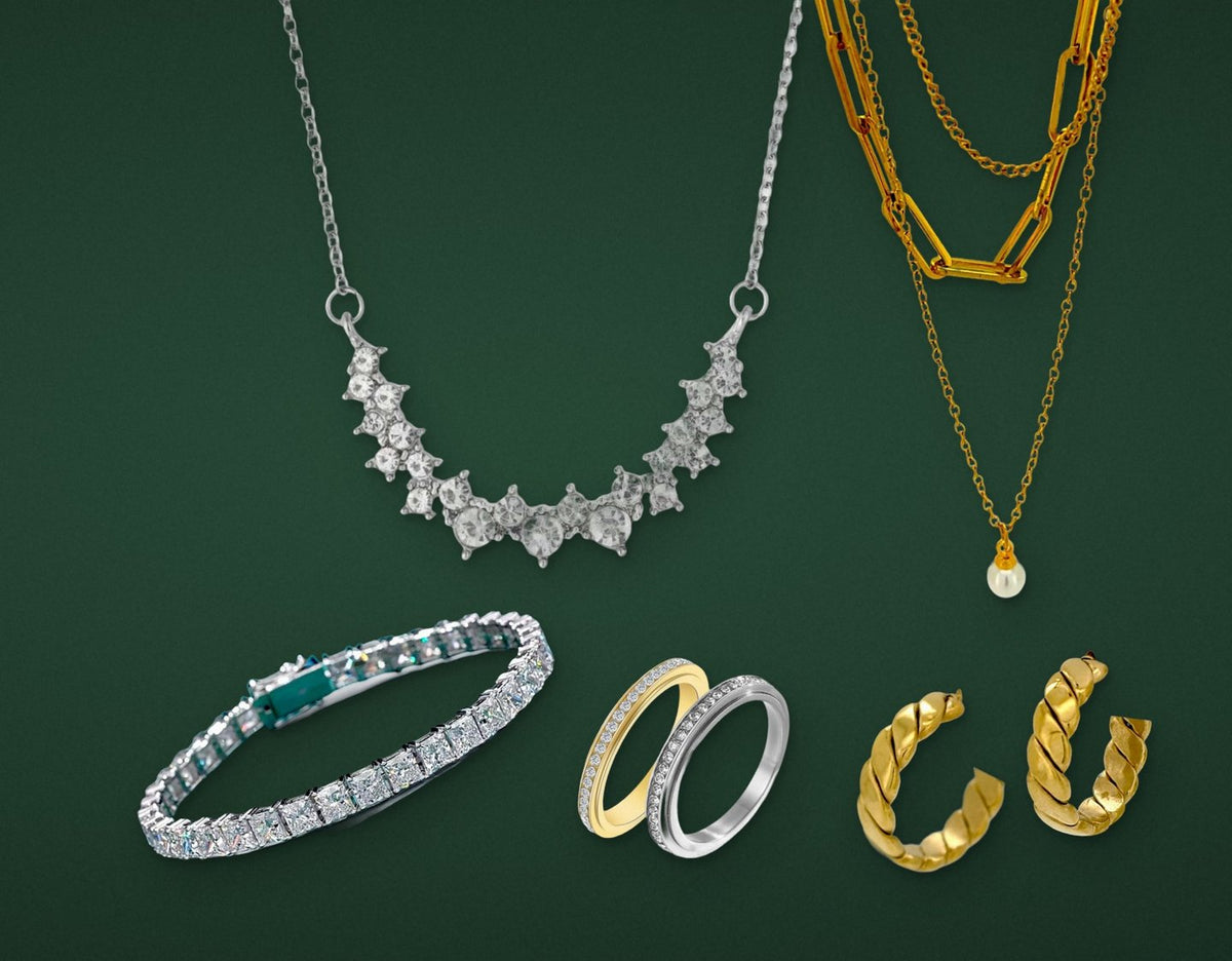Denoon London necklaces, bracelet, rings and earrings on green