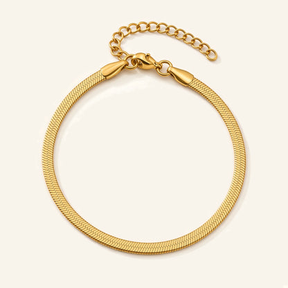 Denoon London gold-tone herringbone snake chain bracelet, flat lay