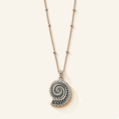Denoon London shell pendant necklace in silver-tone, flat lay
